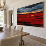 Prairie Embers red prairie and golden horse painting shown at an angle above a light wood dining table