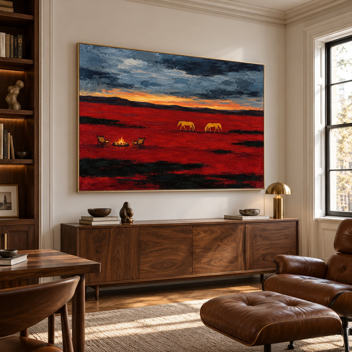 Prairie Embers western horse landscape above a walnut sideboard beside bookshelves and a leather reading chair
